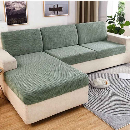 Un salon avec la Housse de Canapé Extensible vert